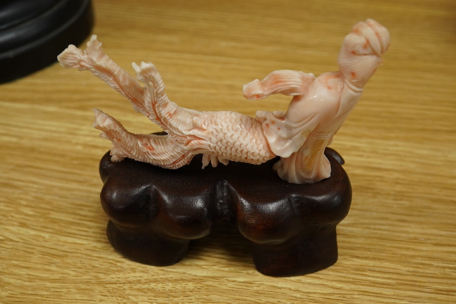 A Chinese coral group of a lady and a phoenix on carved hardwood base, 11cm high. Condition - good